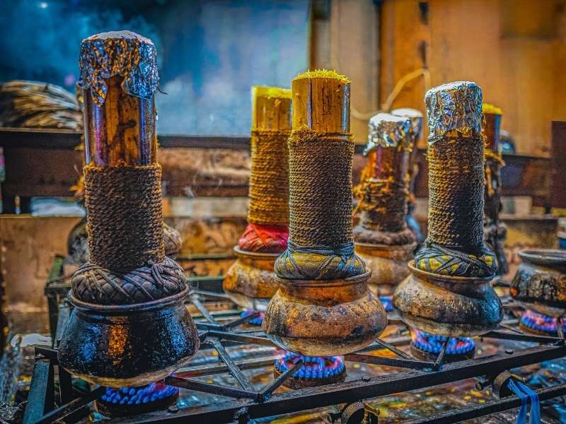 Local vendors using traditional cooking methods at a Colombo street food stall at night