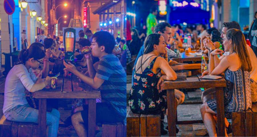 Two groups seated and tasting food during an evening Colombo Food Tours experience